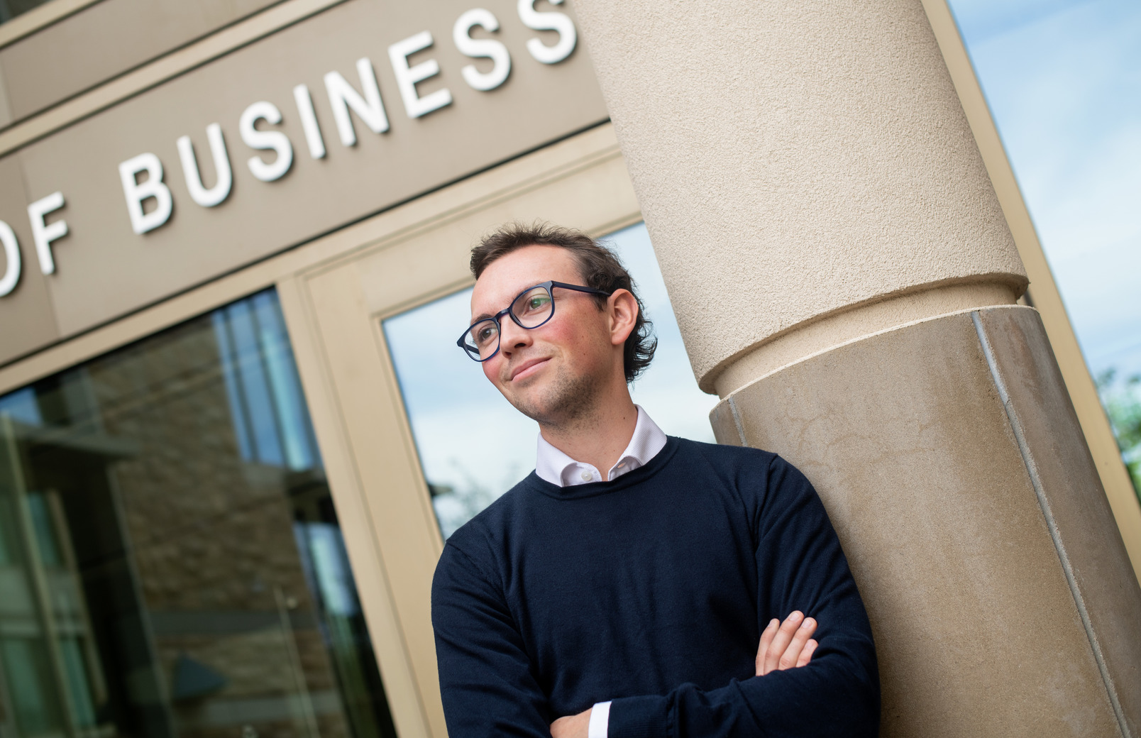 Student standing outside of the College of Business