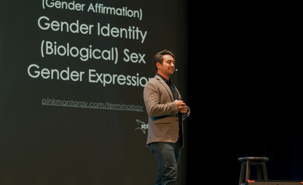 A presenter presents on gender subjects
