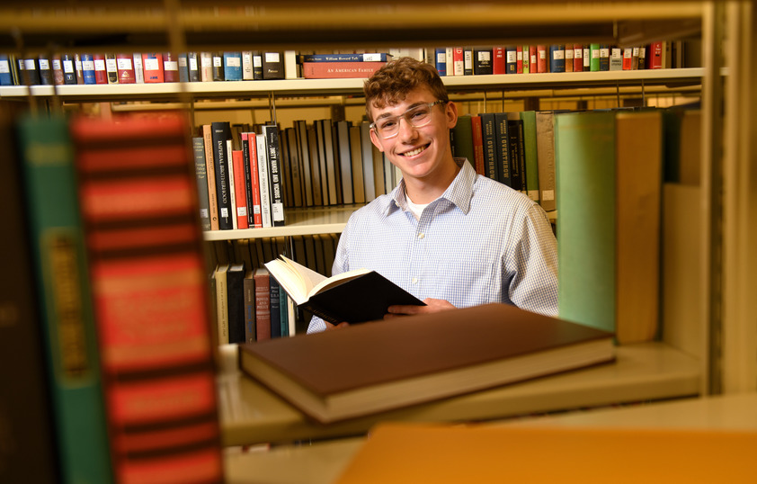 A student reads inside the library sections.