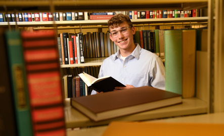 Student reading a book in a UW library