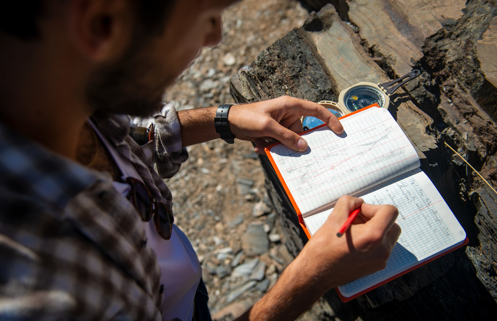 Student writing in field book