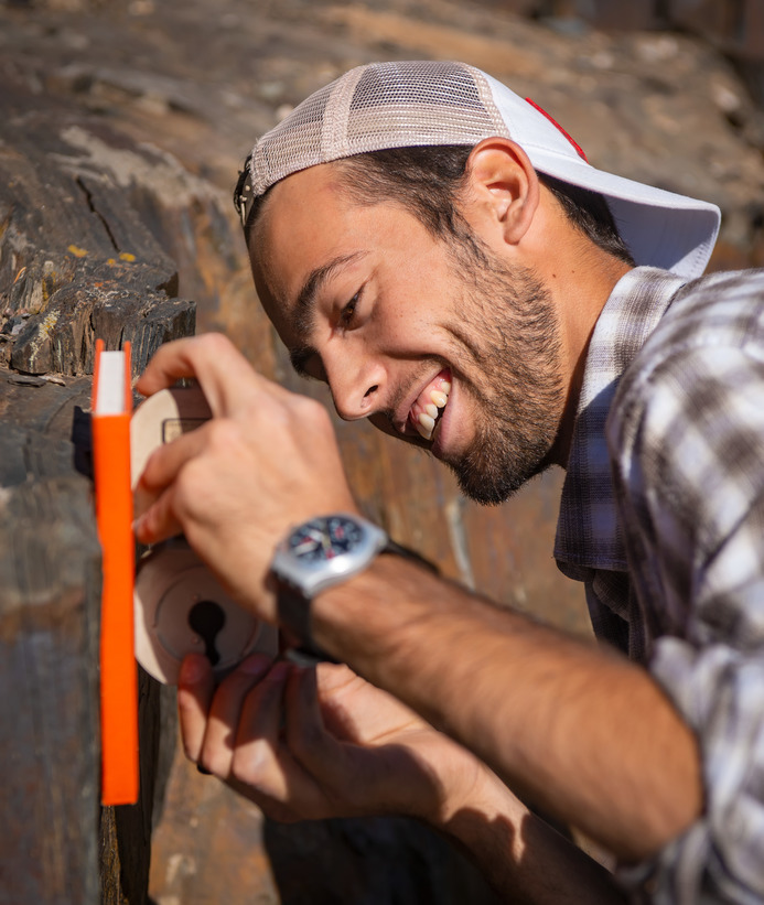 A geology student takes measurements in the field