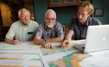 Three geologists sit at a table together