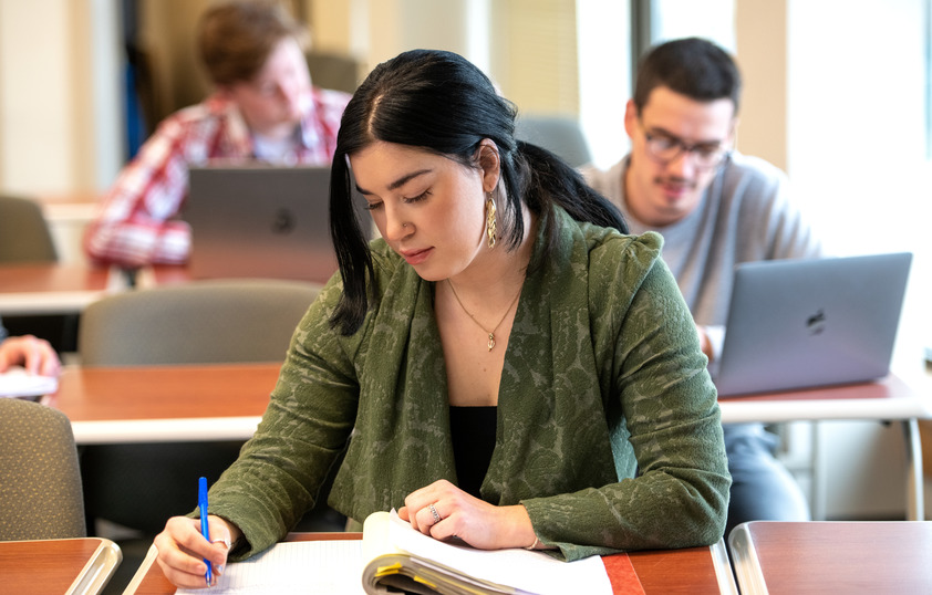 Student writing in class