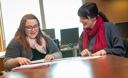 Two UW community members working at a table