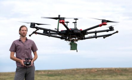 A professor flys a drone