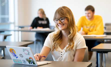 A student works on their laptop in class