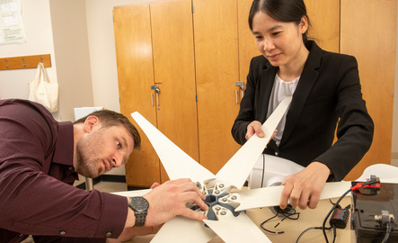 A professor and student work together on a project