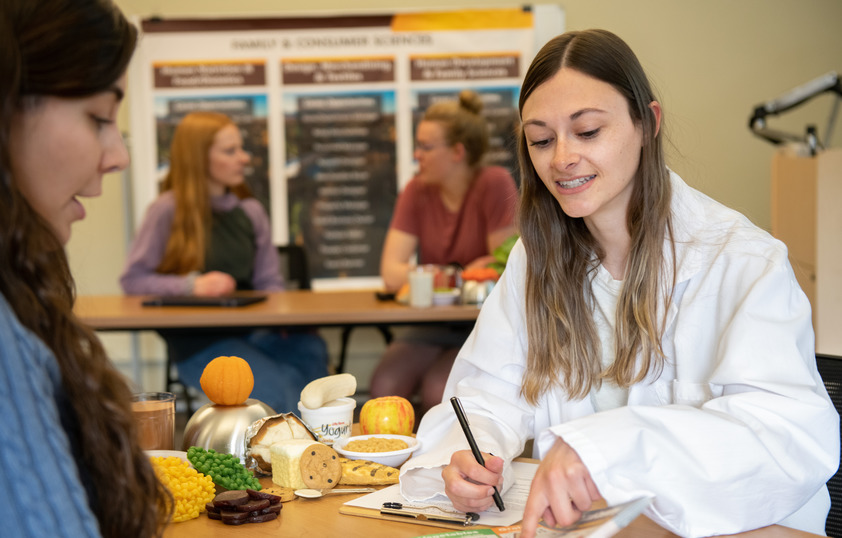 Two students in a family consumer science class working on a nutrition assignment