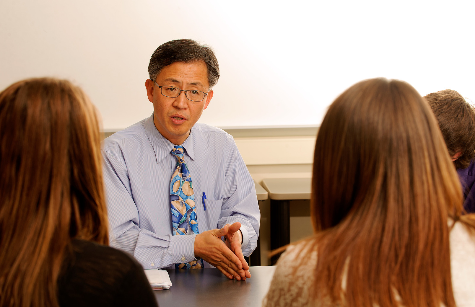 Faculty member speaking with students