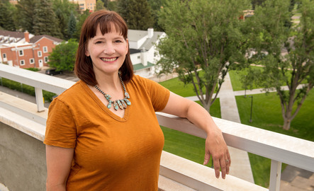 An academic advisor smiles for a photo