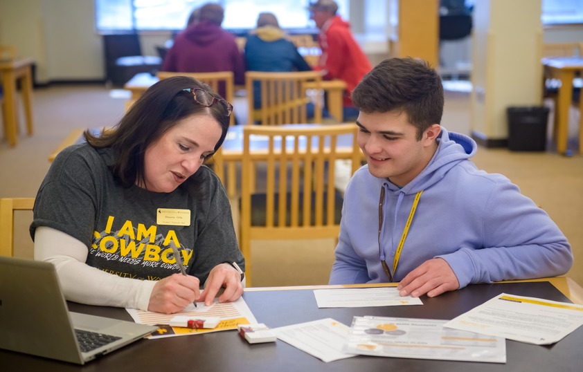 Staff member helping student