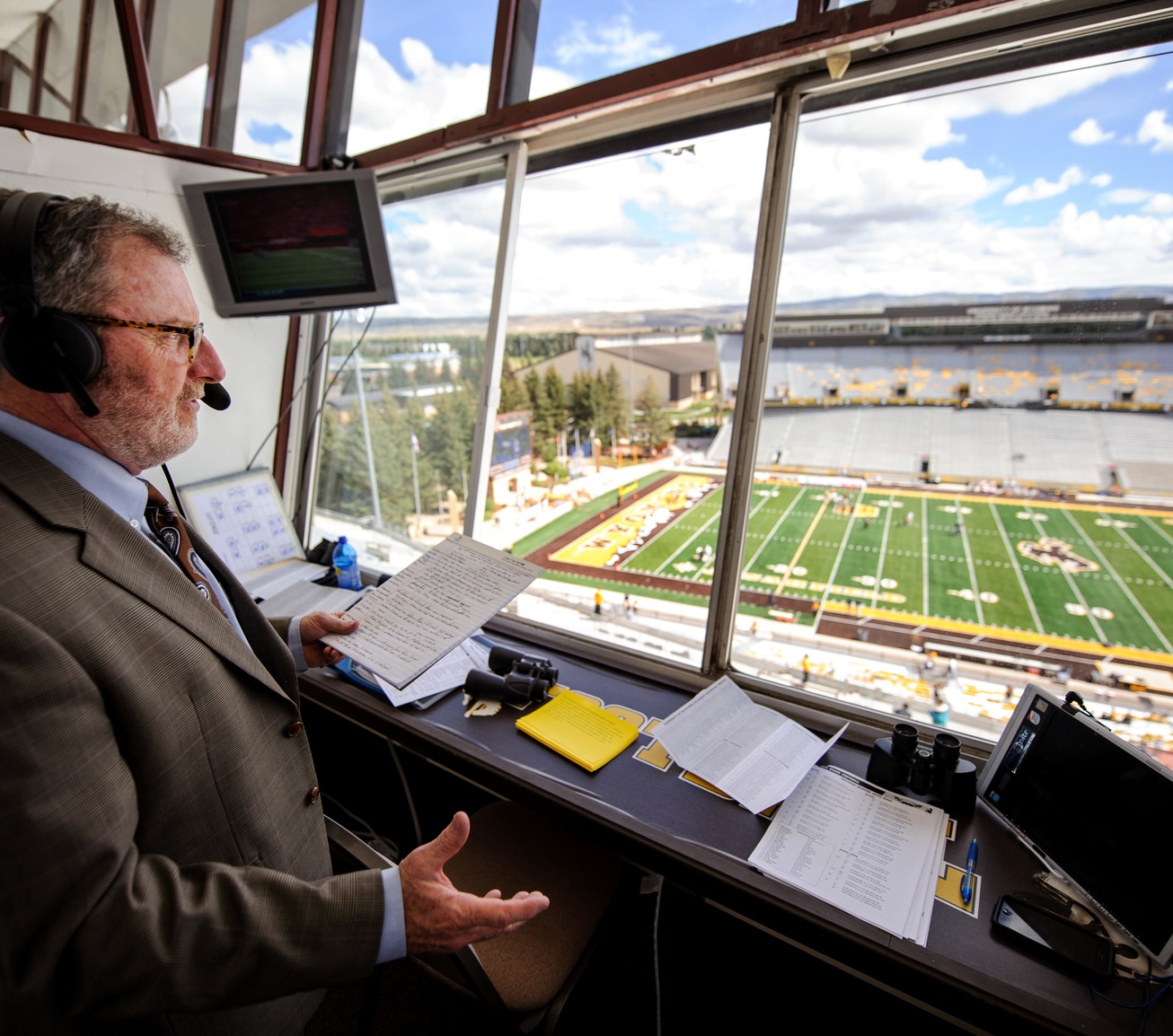 Athletic director in sky box at football stadium