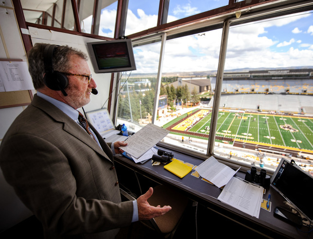 A sports announcer announcing from a press box
