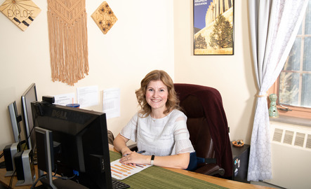 An academic advisor smiles for a photo