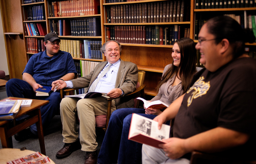 Professor teaching students in library