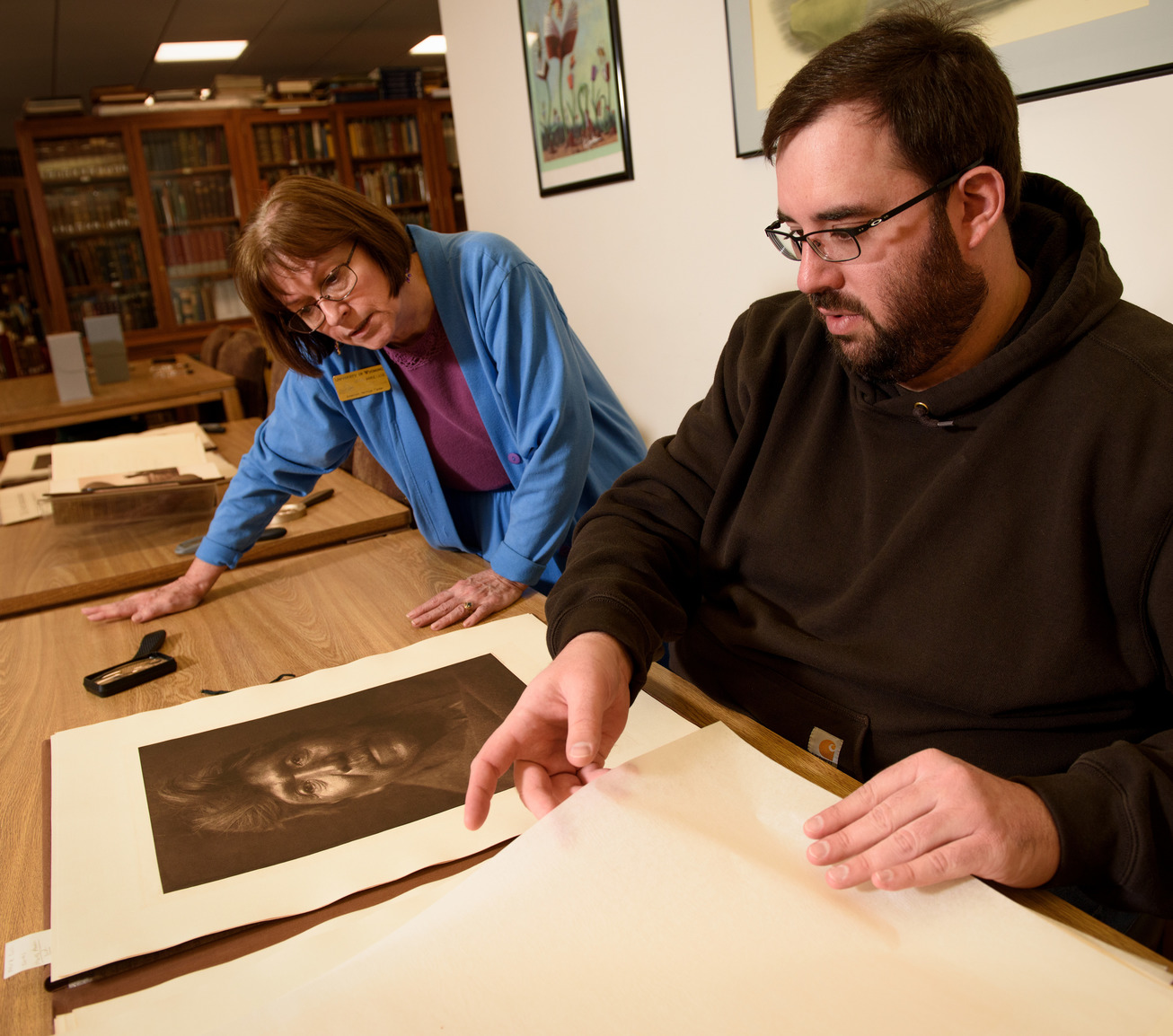 Professor and student looking at historical image together