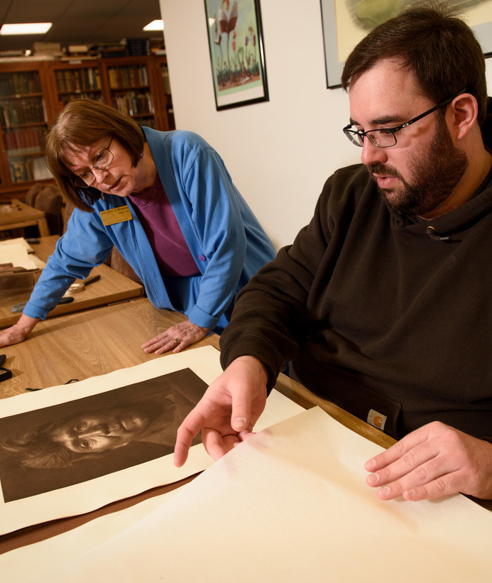 Professor and student looking at a historical image together