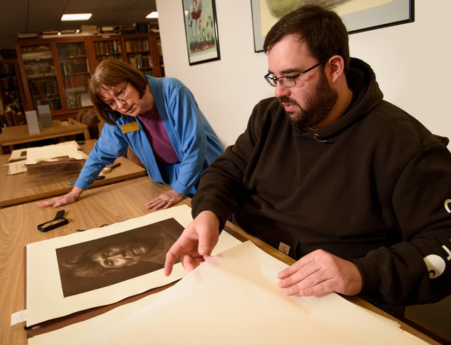 Professor and student looking at a historical image together