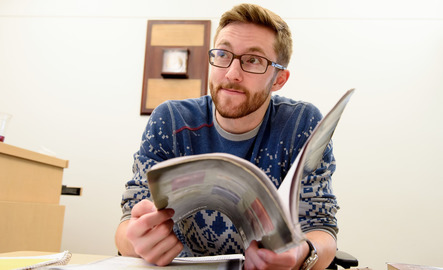 Student opening a book