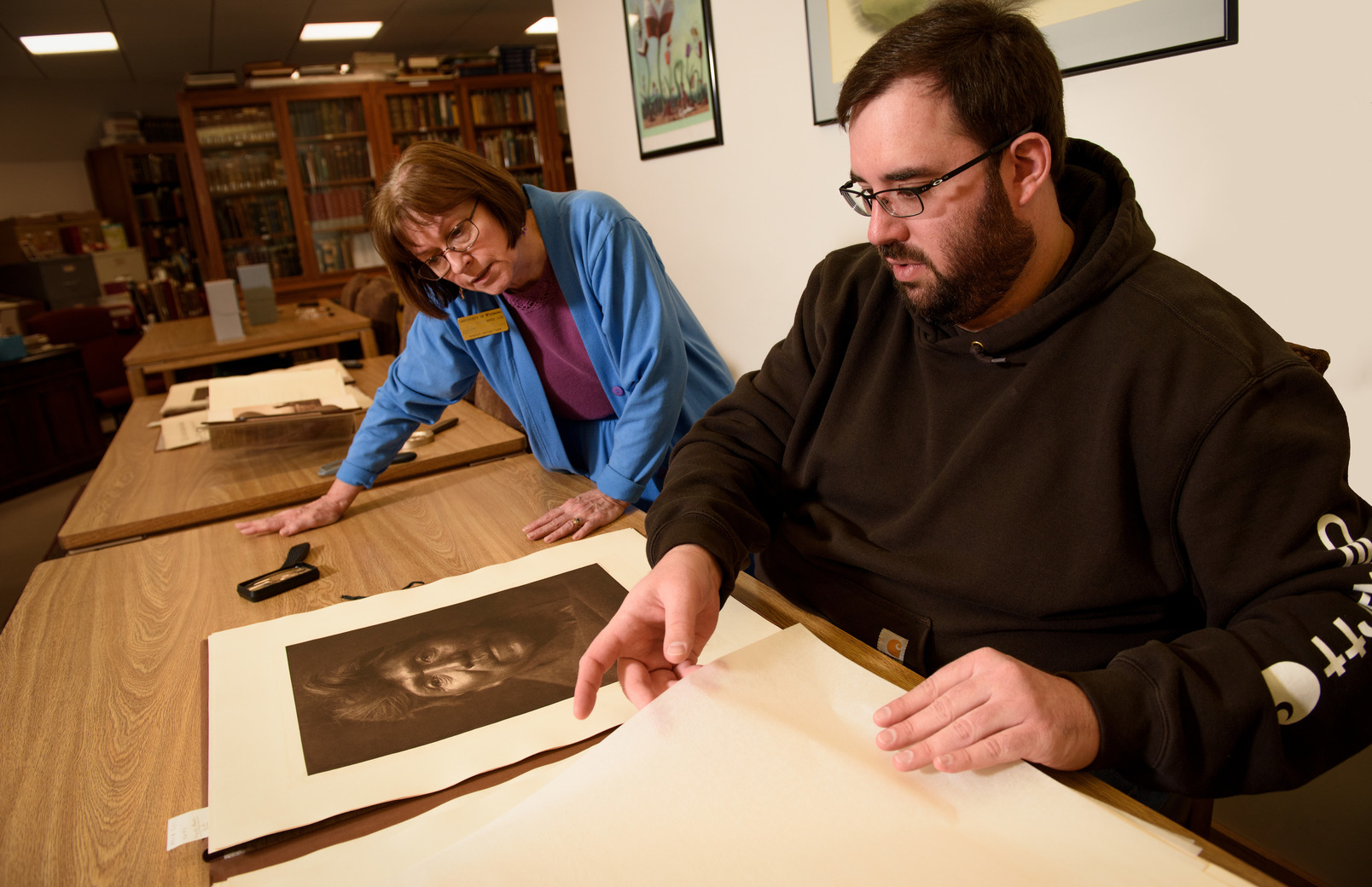 Student and professor looking at photos