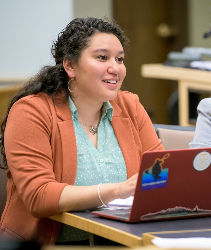 An HR student works on a laptop at a desk