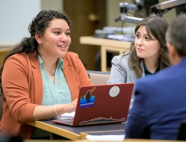 An HR student works on a laptop at a desk