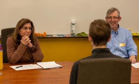 Two faculty members conduct a mock interview with a student