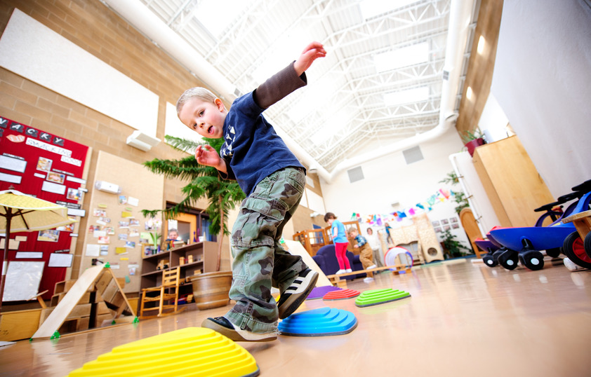 Child playing on plastic stepping stones