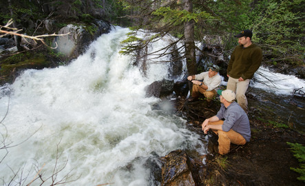 Hydrology professor and student observe water flow