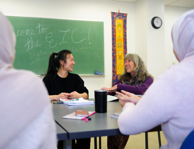 A student and teacher talk during class in the English Language Center