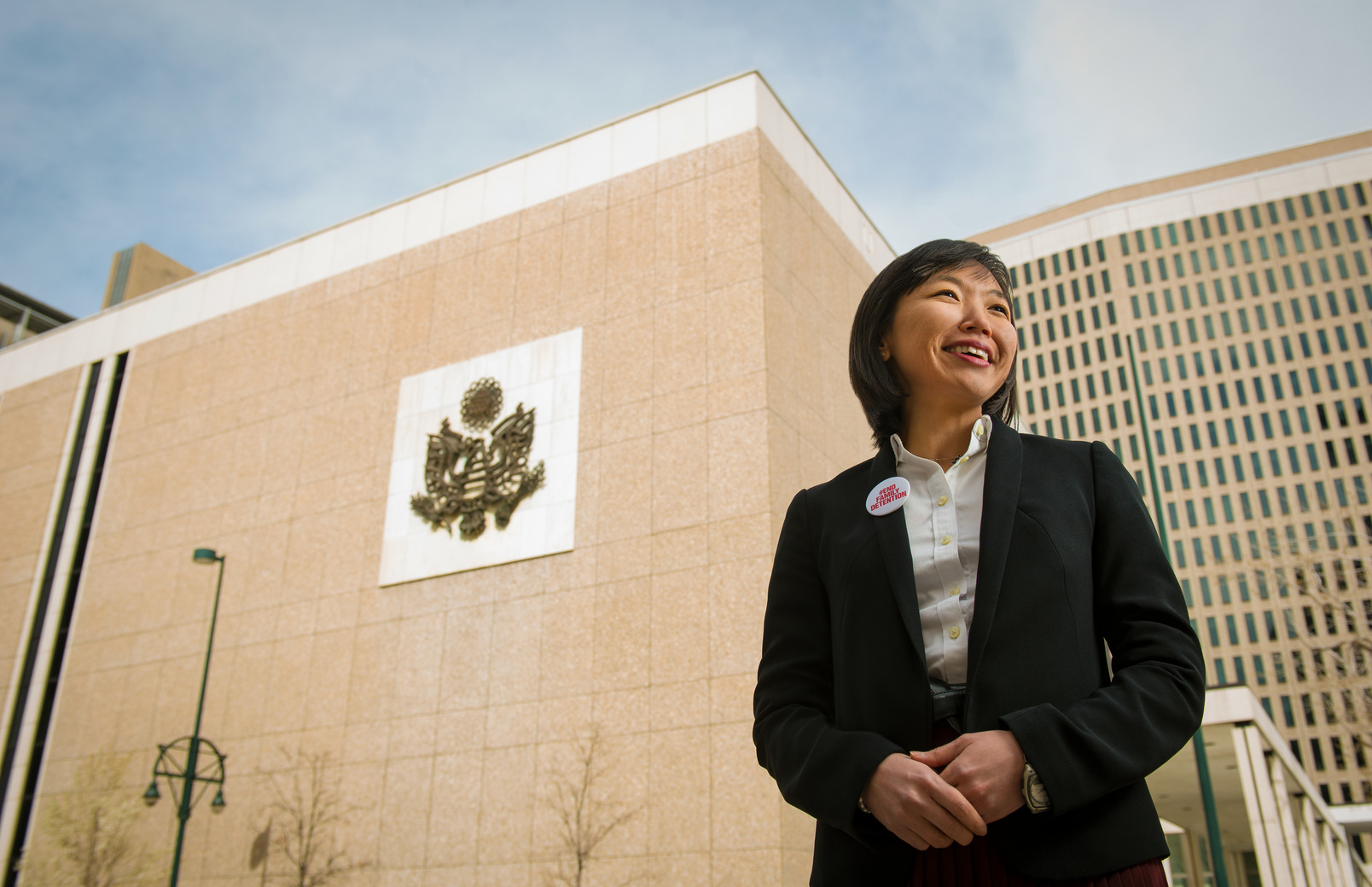 Alum standing outside building