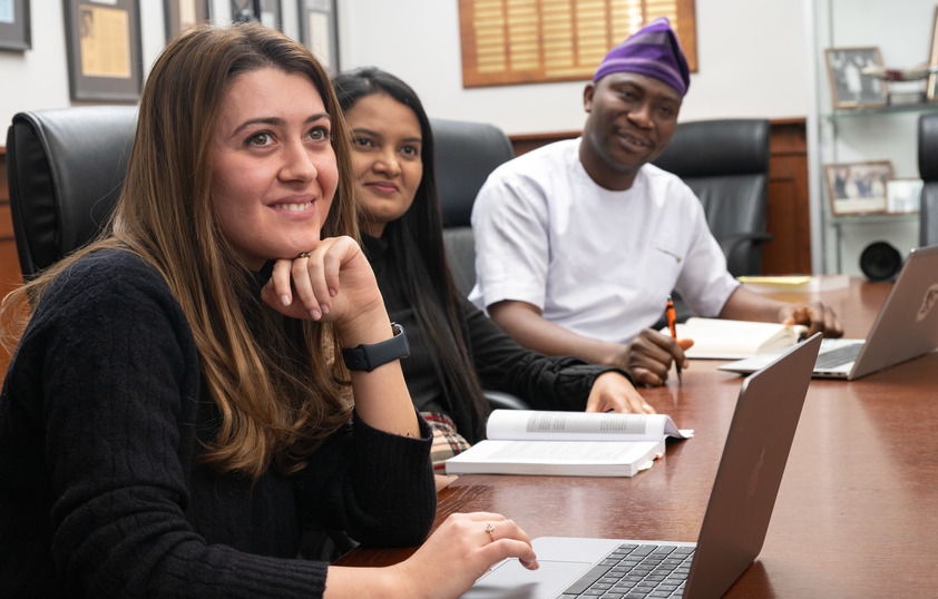 Three students listen in class