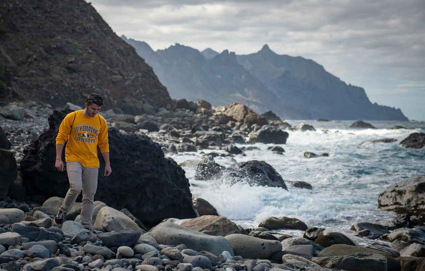 Student walking on rocks