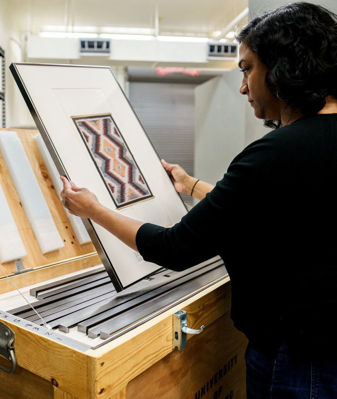 Interior designer looking at art work