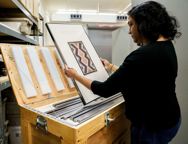 An interior designer looking at art work