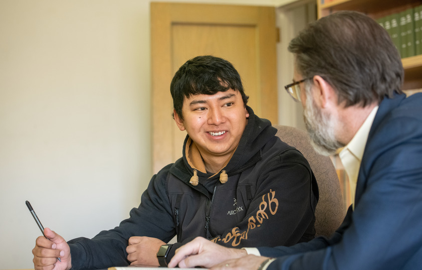 A student works with a professor