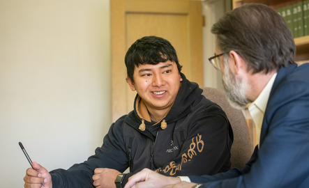 A student works with a professor