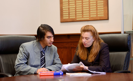 International relations professor looking through files with student