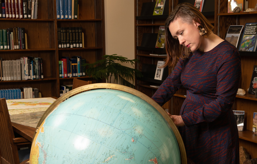 A student looks at a globe