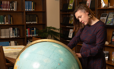 Japanese minor student looks at a globe