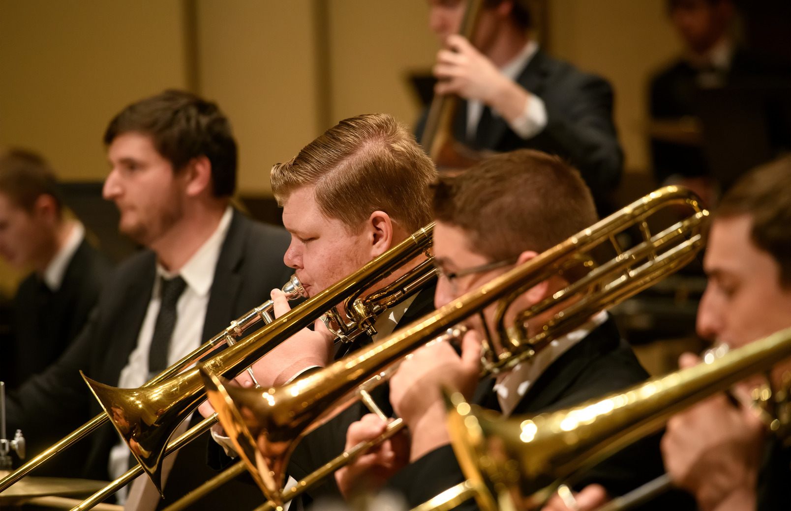 Trombone section playing during a concert
