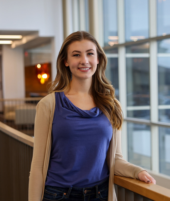 A student smiles