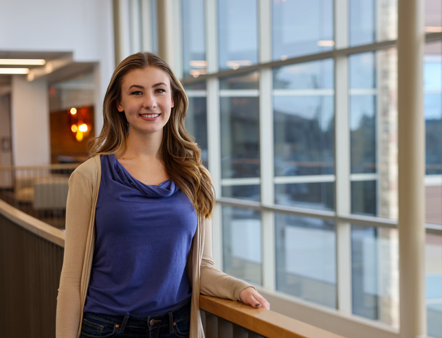A student smiles