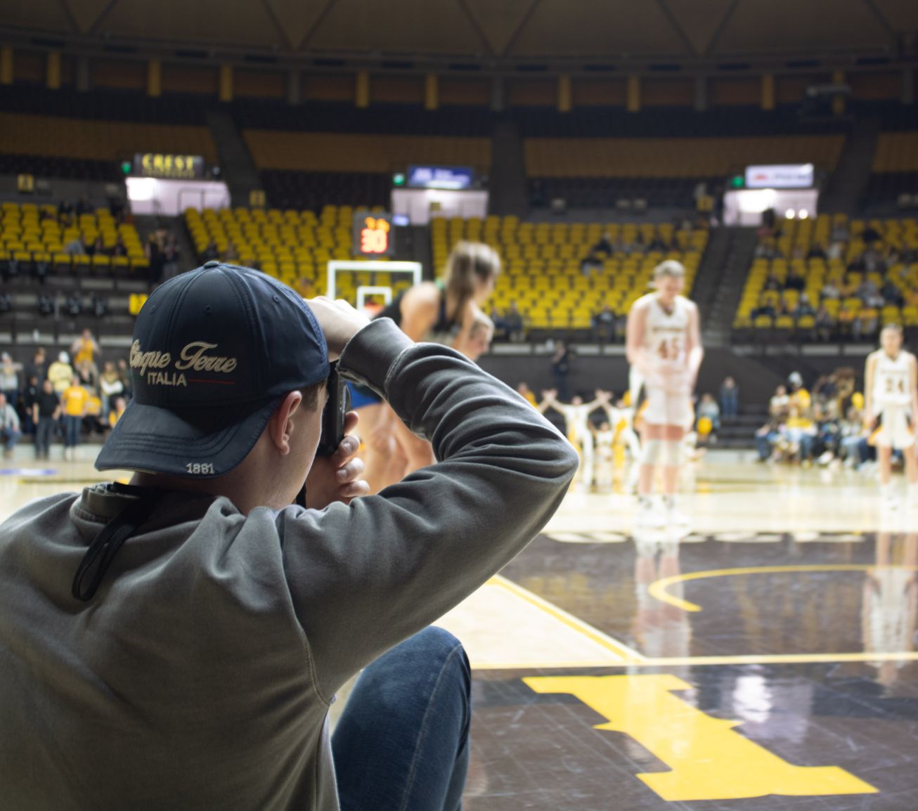 Student taking photos at basketball game