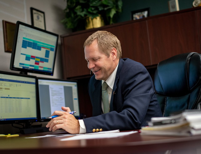A land admin works at his desk
