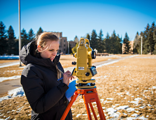 Student looking through civil engineering equipment
