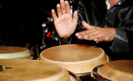 A person plays the hand drums
