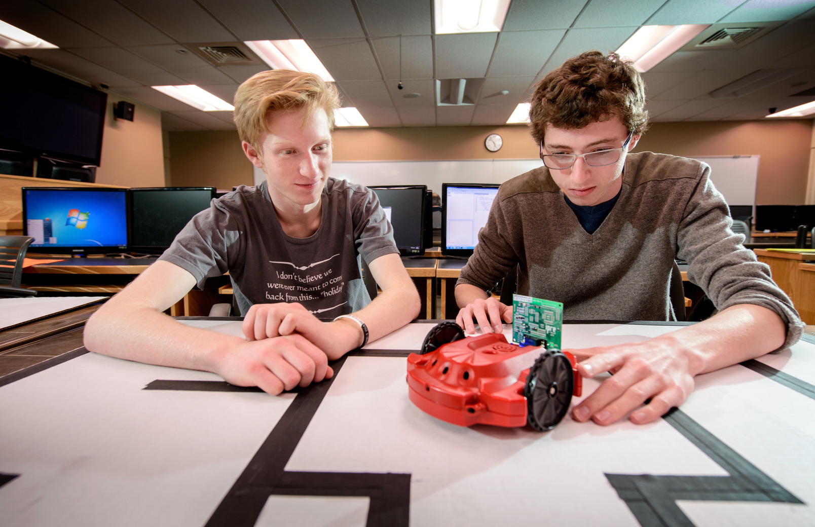 Students working with small electric car