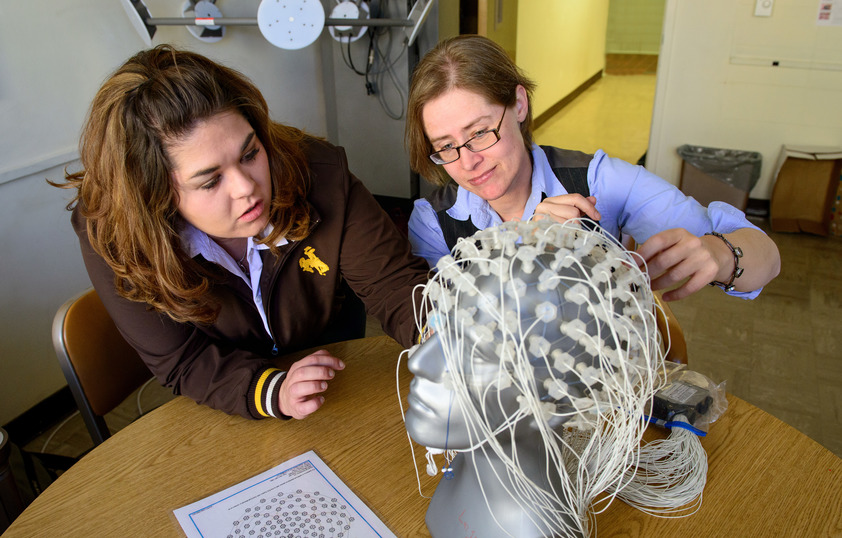 Student and faculty member working with brain wires